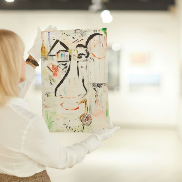 Woman Holding Abstract Painting in Art Gallery